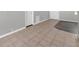 Partially tiled living room area with light gray interior, leading to a doorway at 3624 Hendrix St, New Port Richey, FL 34652