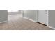 Partially tiled living room area leading to a bright, window filled space at 3624 Hendrix St, New Port Richey, FL 34652