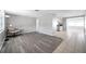 Open-concept living room with modern flooring and great flow to the kitchen area at 3624 Hendrix St, New Port Richey, FL 34652