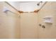 Tiled shower featuring wall-mounted fixtures and built-in shelves offering a clean and convenient bathing experience at 3624 Hendrix St, New Port Richey, FL 34652