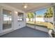 Screened porch with a view of the backyard featuring white fencing, lawn, and tree offering serene outdoor relaxation at 3624 Hendrix St, New Port Richey, FL 34652