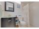 Well-maintained bathroom with modern fixtures, decorative mirror, and tiled walls at 3633 Richboro Dr, Holiday, FL 34691