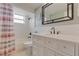Bathroom featuring a vanity with drawers and an oversized mirror at 3633 Richboro Dr, Holiday, FL 34691