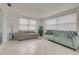 Cozy living area with comfortable seating arrangements and sun filled windows with views of the outdoors at 3633 Richboro Dr, Holiday, FL 34691