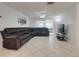 Inviting living room area with plush seating, ceiling fan, and a sliding door for natural light at 3633 Richboro Dr, Holiday, FL 34691