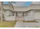 Close-up of cozy porch with seating, metal roof, privacy fence, and an inviting entrance to this charming home at 3633 Richboro Dr, Holiday, FL 34691