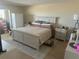 Bright bedroom features a comfortable bed, dresser and large wardrobe for ample storage space at 4725 Cove Cir # 810, St Petersburg, FL 33708