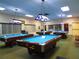Spacious game room featuring multiple pool tables and cozy lighting for enjoyable leisure time at 4725 Cove Cir # 810, St Petersburg, FL 33708