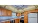 Bright eat-in kitchen featuring honey colored cabinets and white subway tile backsplash at 4725 Cove Cir # 810, St Petersburg, FL 33708