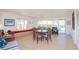 Bright living room with seating, a dining table, and water views at 4725 Cove Cir # 810, St Petersburg, FL 33708