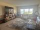 Spacious living room with modern furniture, a large window and water view at 4725 Cove Cir # 810, St Petersburg, FL 33708