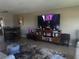Open concept living room featuring an entertainment center and seating at 4725 Cove Cir # 810, St Petersburg, FL 33708