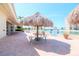Charming patio area with a thatched umbrella table and seating, perfect for outdoor dining at 4725 Cove Cir # 810, St Petersburg, FL 33708