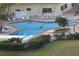 Inviting outdoor pool area featuring ample seating and a vibrant atmosphere for community enjoyment at 4725 Cove Cir # 810, St Petersburg, FL 33708