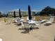 Rooftop terrace with tables, chairs, and umbrellas for outdoor relaxation at 4725 Cove Cir # 810, St Petersburg, FL 33708