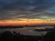 A stunning waterfront view with a vivid orange sunset over the calm water at dusk at 4725 Cove Cir # 810, St Petersburg, FL 33708