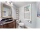 This half bathroom features a unique dark vanity, a window, and neutral paint at 4912 W Bay Way Dr, Tampa, FL 33629