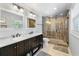 This bathroom features a double vanity, walk-in shower, and updated fixtures at 4912 W Bay Way Dr, Tampa, FL 33629