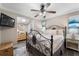 Relaxing bedroom with iron bed frame, ceiling fan and light neutral decor at 4912 W Bay Way Dr, Tampa, FL 33629