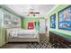 Bright bedroom with natural light, hardwood floors, and fan at 4912 W Bay Way Dr, Tampa, FL 33629