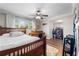 Comfortable bedroom featuring a wood bed frame, ceiling fan, and natural light from the window at 4912 W Bay Way Dr, Tampa, FL 33629