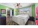 Cozy bedroom with hardwood floors, a large window, and a ceiling fan at 4912 W Bay Way Dr, Tampa, FL 33629