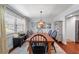 Elegant dining room with a chandelier, large windows, and seating for six at 4912 W Bay Way Dr, Tampa, FL 33629