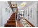 Inviting entryway featuring wood floors, staircase, and a decorative rug leading to the game room at 4912 W Bay Way Dr, Tampa, FL 33629