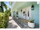 Charming front entrance with double doors, stylish lanterns, and lush landscaping at 4912 W Bay Way Dr, Tampa, FL 33629