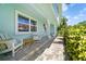 Inviting front porch with seating and brick walkway, offering a relaxing outdoor space at 4912 W Bay Way Dr, Tampa, FL 33629