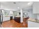 Open kitchen featuring an island, granite countertops, stainless steel appliances, and hardwood floors at 4912 W Bay Way Dr, Tampa, FL 33629