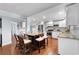 Bright kitchen featuring an island, white cabinets, stainless steel appliances, and hardwood floors at 4912 W Bay Way Dr, Tampa, FL 33629