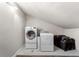 Laundry area equipped with a washing machine, dryer, and luggage storage at 4912 W Bay Way Dr, Tampa, FL 33629