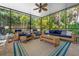 Screened patio with wicker furniture, ceiling fan and views of lush landscaping at 4912 W Bay Way Dr, Tampa, FL 33629