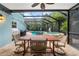 Covered patio featuring outdoor dining with a pool and spa, screened in for pest control at 4912 W Bay Way Dr, Tampa, FL 33629