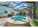 A screened-in pool and spa area with brick pavers and access to an outdoor shower at 4912 W Bay Way Dr, Tampa, FL 33629