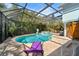 A screened-in pool area with brick pavers and outdoor seating for relaxing near the pool at 4912 W Bay Way Dr, Tampa, FL 33629