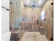 This walk-in shower features custom tilework, a built-in bench, and a glass enclosure at 4912 W Bay Way Dr, Tampa, FL 33629