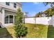 A quaint, fenced backyard with healthy green grass and young trees adds privacy at 5530 N 9Th St # 1, Tampa, FL 33604