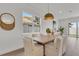 Bright dining room featuring a large window, modern light fixture, and a wooden dining table at 5530 N 9Th St # 1, Tampa, FL 33604