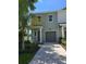 Charming two-story townhome with landscaped yard, paved driveway, and a private entrance at 5530 N 9Th St # 1, Tampa, FL 33604