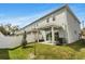 Exterior view of the modern two-story home, showcasing back patio, small yard, and fresh landscaping at 5530 N 9Th St # 1, Tampa, FL 33604