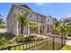 Charming townhomes featuring manicured lawns, small palm trees and decorative front fences at 5530 N 9Th St # 1, Tampa, FL 33604