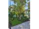 Inviting front yard featuring lush landscaping, a brick pathway, and a well-maintained garden at 5530 N 9Th St # 1, Tampa, FL 33604