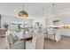 Bright open-plan kitchen and dining area with a modern design and white cabinets and island at 5530 N 9Th St # 1, Tampa, FL 33604
