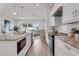 Modern kitchen with stainless steel appliances, white cabinets, and a view to the living room at 5530 N 9Th St # 1, Tampa, FL 33604