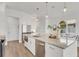 Bright kitchen features a large island with granite countertops, stainless steel appliances, and pendant lighting at 5530 N 9Th St # 1, Tampa, FL 33604