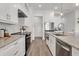 Modern kitchen with white cabinets, stainless steel appliances, gray countertops and wood flooring at 5530 N 9Th St # 1, Tampa, FL 33604