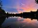 Picturesque lake mirroring a colorful sunset sky, casting a serene and reflective scene at 5530 N 9Th St # 1, Tampa, FL 33604