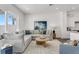 Spacious living room featuring a comfortable sectional sofa, round wood coffee table, and access to a patio at 5530 N 9Th St # 1, Tampa, FL 33604